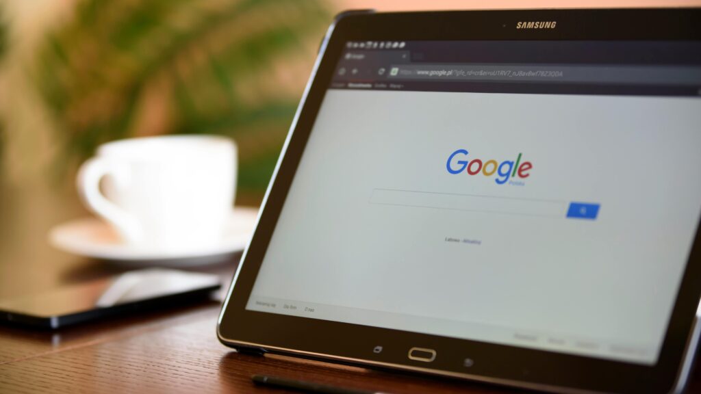Samsung tablet on desk showing Google homepage, perfect for technology-related content.